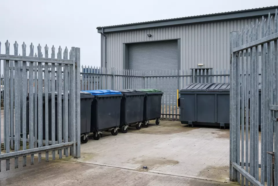 Commercial waste bins at a business yard