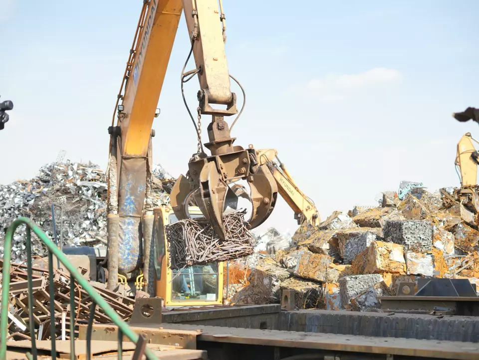 A scrap handler loading heavy scrap metal
