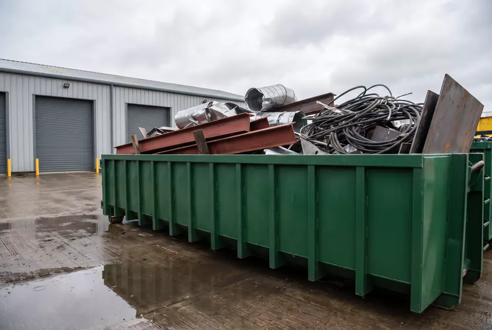 A roll-on roll-off container loaded with heavy scrap metal
