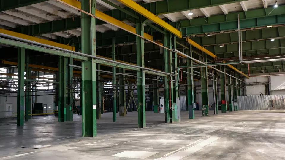Inside a factory strip-out with plant removed and steelwork exposed